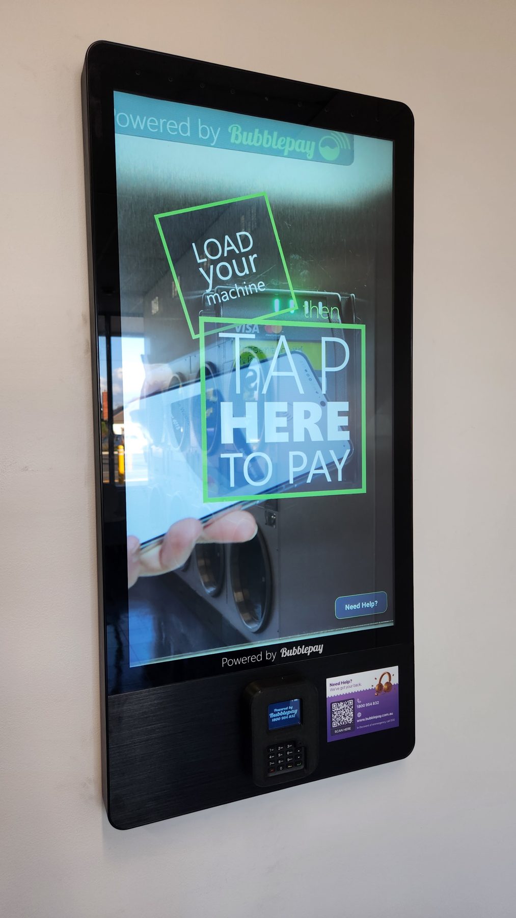 The in-store Bubblepay kiosk screen reading Load your machine, then tap here to pay